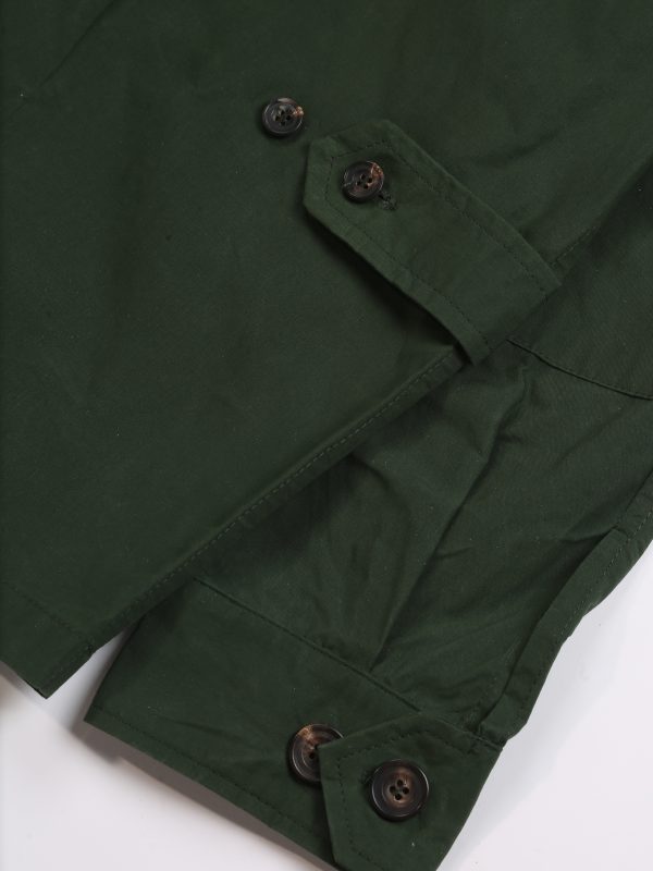 Close-up of the TARGA Jacket in olive waxed cotton showing adjustable button cuffs and waxed fabric texture.